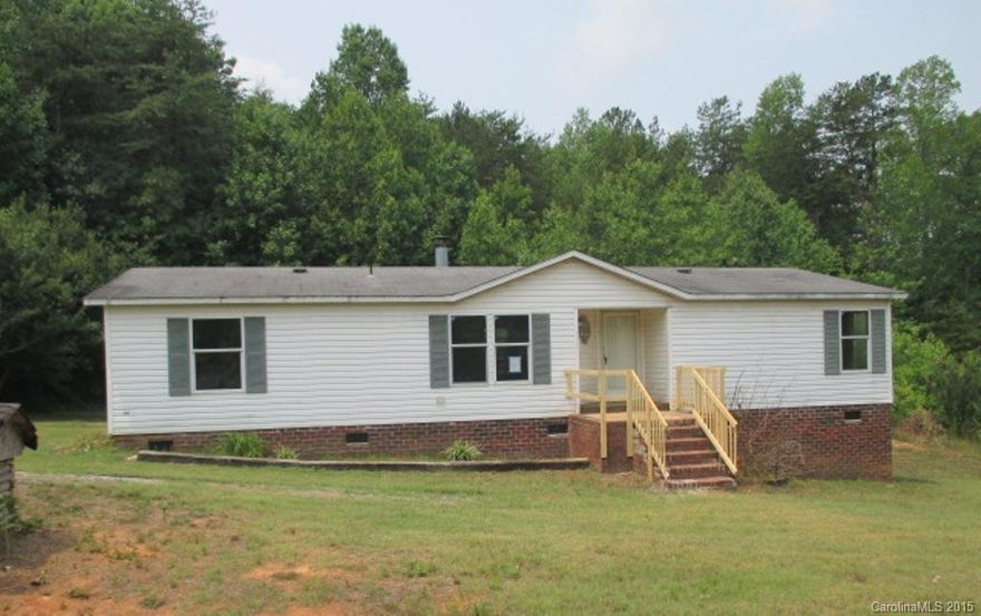 Manufactured doublewide home on 0.46 acre lot features 3 bedrooms, 2 bathrooms, open kitchen, living room, and dining room. Features include fireplace, neutral colors, wooded view at the back. Total SqFt is 1351