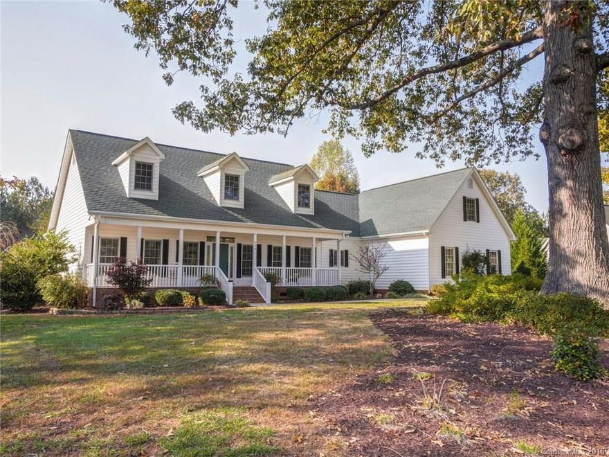 Nestled in the shade of an historic Oak rests this beauty with a rocking chair front porch on 2.5 acres of gardens, quintessential southern living. Tiled floors (no carpet here!) lead you through large open living areas with a big kitchen and a dream of an owner’s retreat. Use your imagination with unfinished upstairs. Bring your horse and ride the miles of equestrian trails in Derby Downs.