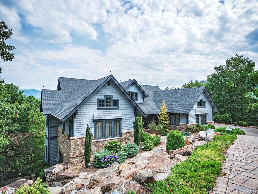 Owner is taking a nearly $2,000,000 loss on his magnificent custom home, designed to showcase the gorgeous views of the Swannanoa Valley and mountain ranges. This home features extensive landscaping with a huge waterfall and stone terraces. The interior features a 2 story great room with massive stone FP on upper and lower levels, gourmet kitchen with Wolf & SubZero appliances and rare granite, custom stained glass cabinets, lower level kitchen, 2 laundry rooms, exercise room & elevator!