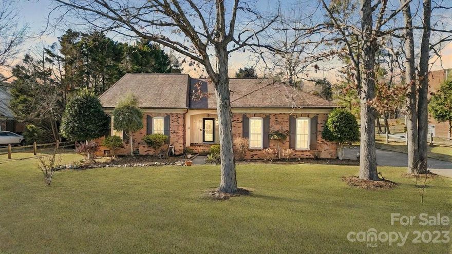 Come tour this immaculate full brick single level 3 bed/ 2 bath home bathed in natural light. Featuring LVP throughout, the open concept welcomes you as soon as you walk through the front door with the vaulted ceilings and wood beams drawing your attention upwards. The large living room features a wood burning fireplace with doors leading to the backyard. The beautiful kitchen features a large island, built-in microwave, and double oven with a gas range. Owner's suite is on a separate side of the home away from the other two bedrooms with a vaulted ceiling and sitting room. The owner's suite bathroom has a walk-in tiled shower, double sinks, and amble closet space. Rest easy knowing the washer and dryer will remain for your convenience. The two-car garage and a long driveway provide ample parking. No HOA restrictions allow you the freedom to do with this wooded lot as you please. Experience the warmth and character of this charming residence – a true gem with every detail considered.