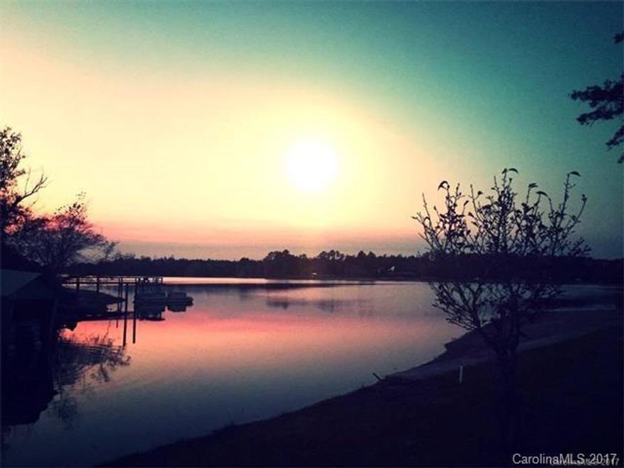 Beautiful Lakefront 1.5 acre, with fantastic Sunset views. Ready to build on. Concrete sea wall, refurbished floating dock for 3 to 4 boats, paved road in cul-de-sac. Lot has unobstructed open view on a small slope and perfect for walk out basement home plan. Public sewer and water available with tap fee about $4176 (please confirm). All underground utilities, and Fiber Optic high speed internet available. No Association fees. Award winning Clover School District.  Co-listing Agent is owner.