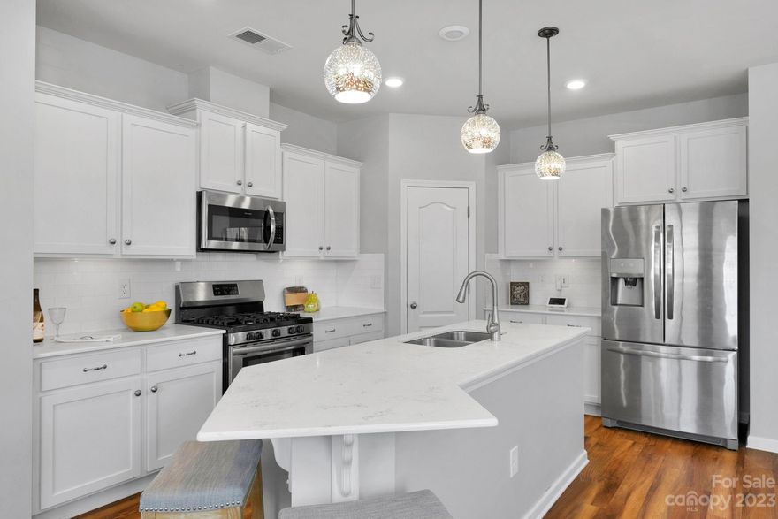 Welcome Home! Spacious END-UNIT Townhome, w/ton of Natural light, located in The Greens in Indian Land, SC. The "TAYLOR C Model" Floor pl has approx. 2000+ HLA! OPEN FLOOR plan, LVP flooring! Family Rm w/gas fireplace! Stunning White Kitchen w/Granite counter tops & Island. Subway tile backsplash. W/I Pantry! Shaker Cabs w/under lighting! Modern light Fixtures! Huge open Dining area! Primary Ensuite Bedrm on Main features tiled shower, garden tub & dual sink vanity. Upper level features HUGE Bonus room ideal for  Home office, Home theater and/or game room. Both secondary bedrms a are spacious w/WI closets & Full bath w/dual sink vaniety!. Sep. Laundry Room. Detached oversized 1-Car Garage has alley access w/ Addt'nl adjacent parking! Partially fenced back yard! Nice Community Pool and Cabana just across the Street! Desirable Indian Land w/lower SC TAXES, Highly rated schools! Close to Promenade @ Carolina Reserve Shopping Ctr. HT & Health care facilities! Lawn care included.