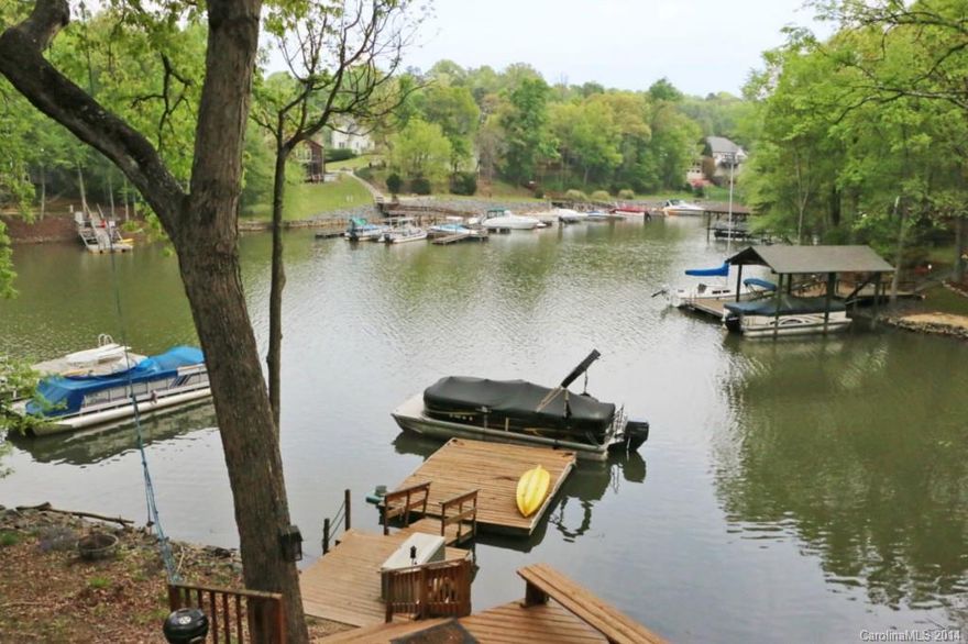 Tega Cay waterfront home with beautiful view of an open cove! Enjoy the lake scenery outdoors from two screened porches, patio, deck or floating dock.  Lots of large windows overlooking the water from open living areas. You won't believe the master suite, with private den and fireplace, opening up to a screened porch. Flexible floorplan with up to five bedrooms plus office or exercise room. You'll love the Tega Cay lifestyle: two golf courses, recreational areas, pool, parks & trails.  See tour!