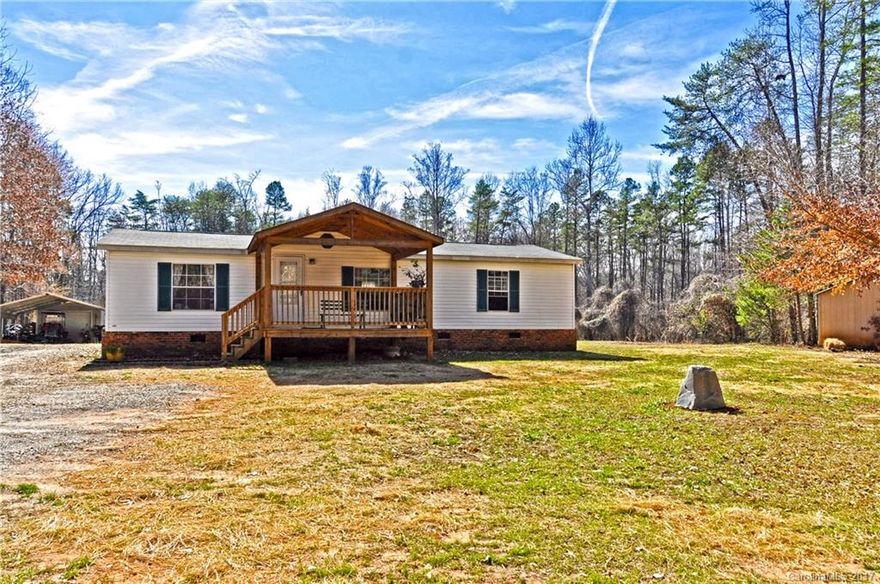 Newly renovated home nestled in a private setting on 7.7 acres of wooded land. Detached 2 Car Carport & Workshop w/100 AMP service. 30 AMP RV hook-up & additional storage shed. New laminate floors throughout. Open concept living area w/vaulted ceilings. Kitchen w/custom cabinet storage & eat-in breakfast area. Renovated master suite w/walk-in closet & laundry. Welcoming covered front & rear porch offer a great place to relax. Located minutes from Downtown Clover w/sought after Clover schools.
