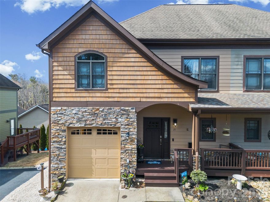 This enchanting townhouse offers the perfect blend of secluded peace and urban convenience. Located in West Asheville, you are within minutes of the area's most iconic destinations while remaining tucked away in a private setting. The heart of the home features large windows in the dining area that flood the space with natural light. Anchored by a large center island and equipped with a gas range, the kitchen is perfect for both entertaining and quiet mornings. Retreat to the living room to enjoy the warmth and ambiance of the fireplace. Primary ensuite and 2 additional bedrooms upstairs provide plenty of room for family, a dedicated home office, or personal fitness studio. Attached one car garage for convenience and safety. Enjoy the convenience of being less than 10 minutes from the NC Arboretum, Tanger Outlets, and less than 15 minutes to the Biltmore Estate and Downtown Asheville, convenient to I-26 and I-40.