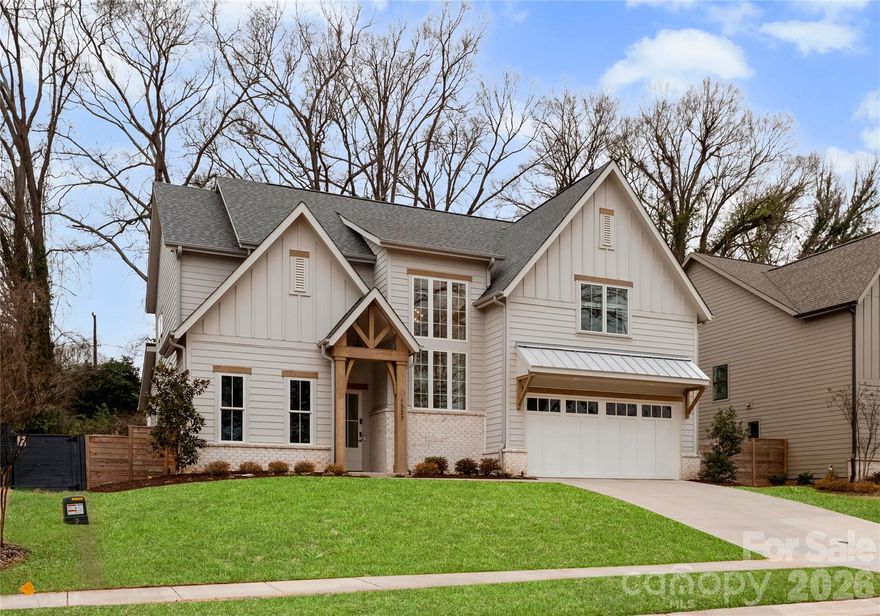 Stunning 3,637 sq ft Barringer Homes build (2023) featuring a rare primary on main layout in the heart of Plaza Midwood. Located just steps from the expanding Briar Creek Greenway and Gold Line, this home offers walkable access to the restaurants, breweries, and retail that make this vibrant neighborhood so desirable. The primary suite features a vaulted shiplap ceiling with beams, a spacious bath with soaking tub and separate shower, and a walk-in closet with space for a stackable washer and dryer. The main level also includes a full bath and a flexible room ideal for an office or guest space. A dramatic two-story foyer with statement staircase and oversized windows fills the home with natural light. The open floor plan centers around a beautifully designed kitchen with KitchenAid gas range, custom cabinetry, pantry, and designer finishes. Enjoy outdoor living with a screened porch with fireplace, paver patio, and a private 74’ wide fenced backyard lined with mature trees.