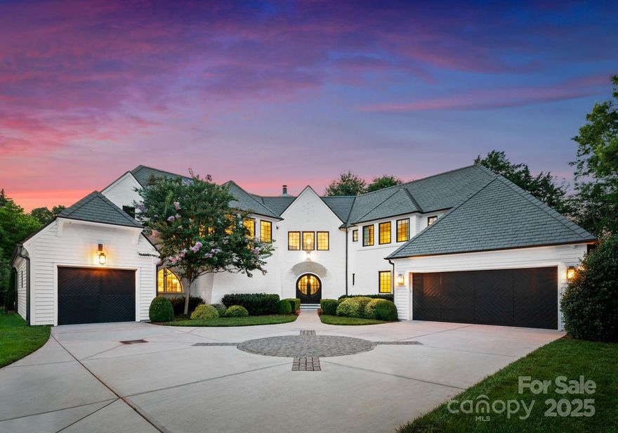 Welcome to 4714 Ockley Manor Drive—where classic elegance meets modern luxury.

Built by Kingswood Custom Homes, this British-inspired home sits in the coveted Ockley Manor community, just a golf cart ride from Carmel Country Club. From the slate roof to the intricate millwork, every detail showcases timeless craftsmanship.
Inside, enjoy soaring ceilings, a chef’s kitchen with high-end appliances, custom cabinetry, and a large island that opens to a sunlit living room with a statement fireplace. The main level offers a luxurious primary suite with a spa-like bath and walk-in closet, plus a private guest suite—ideal for visitors or multi-generational living.

Upstairs, each bedroom features an ensuite bath and walk-in closet. A spacious bonus room—currently outfitted with a golf simulator—can also serve as a 5th bedroom. A dedicated office adds flexibility.
The covered terrace with motorized screens, built-in grill, and salt-water pool, allows for year-round outdoor living.