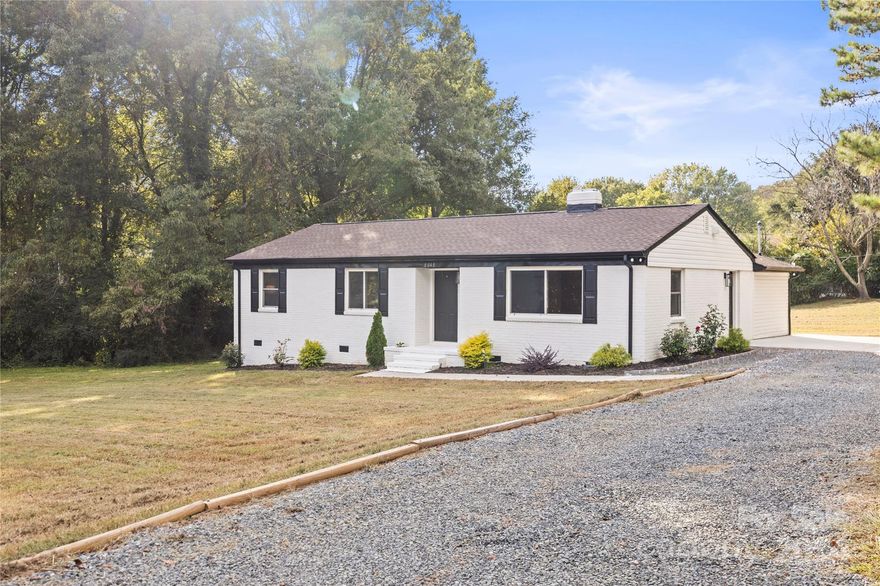 Are you looking for the house with large lot in the middle of the city? Here, it is. Welcome to this charming updated 4 bed 2 bath brick ranch style home with partial vinyl siding, nestled on over an acre of land down a private drive, offering tranquility and privacy rarely found in the area. Inside, new easy-care LVP flooring throughout. The kitchen boasts a generously sized pantry, all new cabinets, quartz countertops, and a stylish backsplash. Additional updates include all new stainless steel appliances, fixtures, modern hardware, and a convenient entrance directly from the driveway. The primary suite located at the rear features serene backyard views through large windows, a walk-in closet, and a modern bathroom with a tile shower. Three secondary bedrooms share an updated bathroom. The living room equipped with new electric fireplace. Recent upgrades include New HVAC, newer roof, cosmetic upfit, new concrete driveway & a concrete patio. Enjoy worry-free maintenance and no HOA.