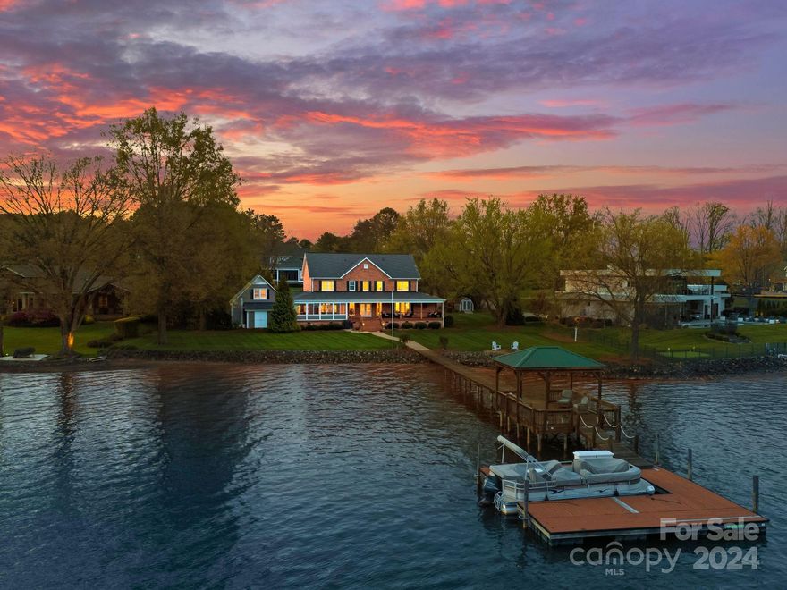 Lake Norman Beauty Beyond The Point! This exquisite waterfront residence offers timeless elegance in prime location. Crafted with traditional full brick, boasting stunning long range views, an inspiring porch for entertaining or relaxing. Large, open and level lot with room for a pool to enjoy the best lake living! Inside, you are greeted by an open inviting floor plan with an abundance of natural light and main level owner's suite featuring floor to ceiling windows. Expansive kitchen with double islands is the perfect canvas for hosting friends and family. This lovely residence has been meticulously maintained and has 4 spacious lake view bedrooms with 2 additional rooms and a bonus room providing ample space for everyone. Take in the views on your private pier with covered sitting area. No HOA. No Restrictions.