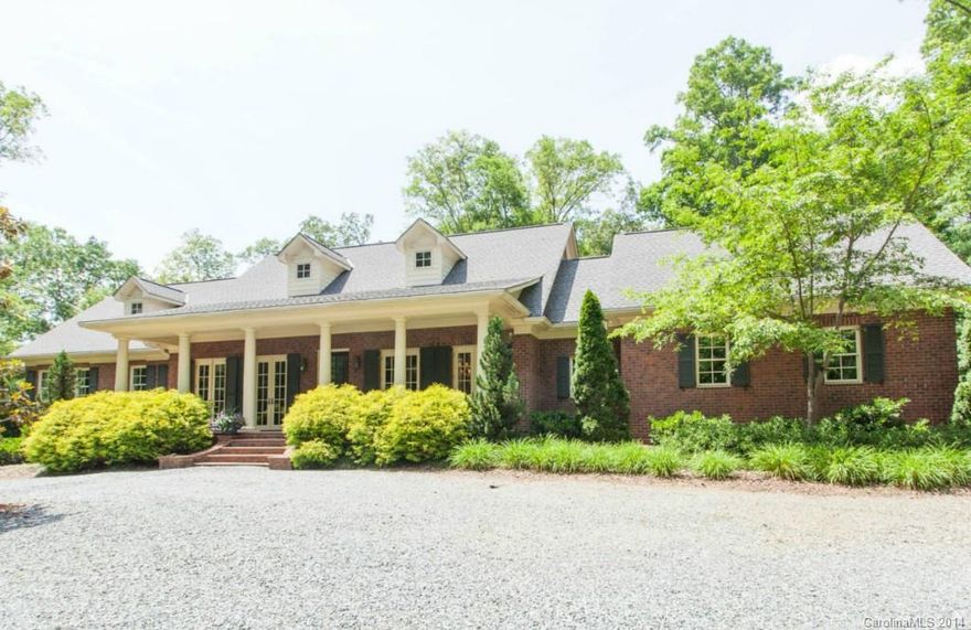 Custom designed and built low-country style home. Sweeping front & back porches w/ views of the secluded 2.28 acre lot. Kitchen features include custom cabinets w/ pull out drawers, stainless appliances, top grade granite, huge pantry and oversize butler's pantry. The master suite is separated from the secondary bedrooms is generously sized w/ lg windows. Master BA includes jetted tub, separate shower, granite counters, his & hers sinks. Hardwoods throughout. Custom designed dog room!