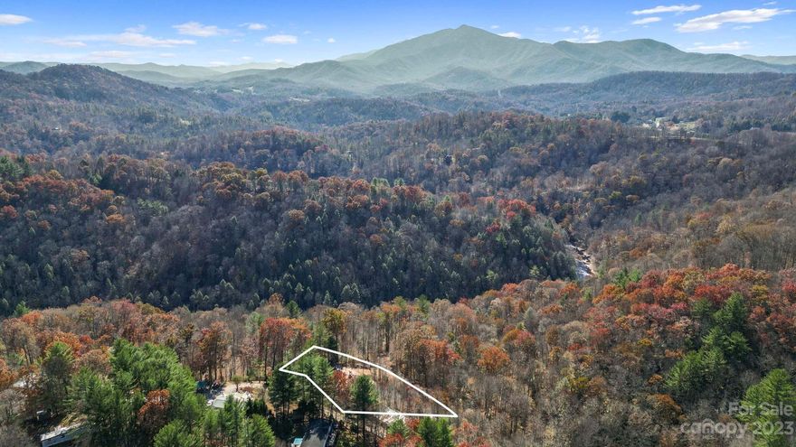 Site work done with septic, well and power; ready for you to place your new home. 1.18 unrestricted acres in Burnsville/Green Mountain area. Close to town yet all the privacy you could ask for,  just off Double Island Road. Picture perfect view of Mt. Celo.  Looking to build that mountain cabin getaway?  Forget the long wait for septic perk, installation  and struggling to get a well driller out in less than 6-12 months. This lot is ready for you to start building immediately!