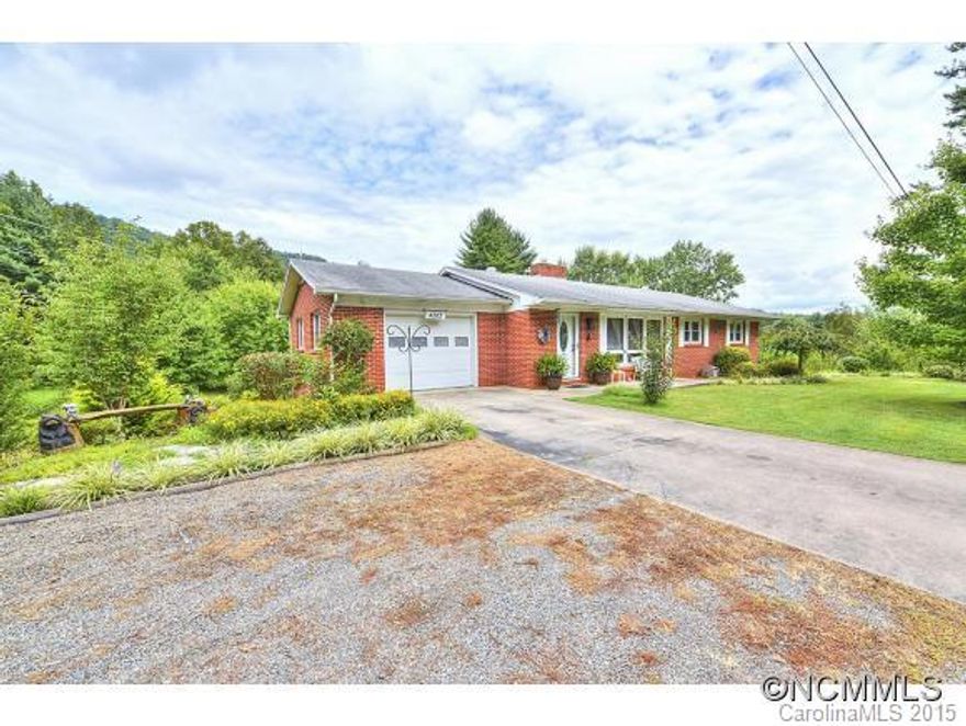 PRIME BRICK RANCHER CLOSE TO TOWN - Mountain Views,Large Back Yard for RV,Hobbies, no restrictions! 3 Bedrooms/2 baths/all hardwoods/updated kitchen with large dining areaand french doors to newer decks overlooking views, New Windows, heated upper Garage(potential to expand)plus High Ceiling Oversize Garage(heat) & room to expand in the lower garage. Landscaped -Heat with wood or furnace option, heat pump for cooling, two parcels for one price!