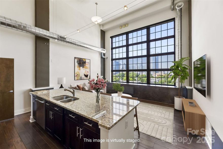 The LIEN has been SETTLED AND RECENT PRICE REDUCTION! Welcome to The Garrison at Graham, where ideal location meets nearby access to all that the Charlotte uptown offers! Welcome to this 6th floor (top-level) condominium with a Charlotte uptown skyline view!  Unit #604 offers one wall of windows that flood the great room and entire unit with natural light, with the option of privacy with motorized blinds. The main floor also offers a beautiful kitchen with a substantial island and a bedroom/office with a full bathroom and W/D. The primary loft bedroom upstairs has a walk in closet, full bathroom with a garden tub and separate shower. There is a large Rooftop Terrace a few doors down the hallway from this unit - be sure to check it out with the key FOB! The rooftop terrace has a grilling station, refrigerators, seating tables and couches. Building amenities include assigned parking (2 spaces w/a lift), assigned visitor parking, secure entry, and elevators. Recent repair summary available upon request.