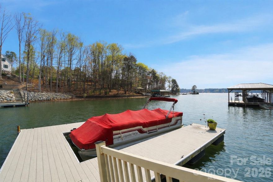 Welcome to 107 Nautilus Court in Troutman—a remarkable waterfront retreat that blends timeless craftsmanship with modern functionality. Built in 2004 and thoughtfully maintained, this all-brick estate is set on a beautifully landscaped 1.16-acre lot, offering both privacy and sophistication. From the moment you arrive, you’ll notice the meticulous attention to detail, from the classic architecture to the lush grounds that frame the home and invite you into a world of serene lake living. The exterior is a true work of art, with every element designed to impress. The second-floor patio features a herringbone brick design that showcases the builder’s craftsmanship, while raw iron steps gracefully descend to the pool area, blending durability with elegance. The swimming pool itself has recently been resurfaced in travertine, creating a timeless backdrop for summer gatherings, relaxing afternoons, or evenings spent entertaining under the stars. Nestled on a quiet cove with deep water, Here, you can soak in peaceful, uninterrupted water views while still being close to everything the lake lifestyle has to offer. Inside, the home continues to impress with thoughtful design and luxurious finishes. Gleaming hardwood floors flow seamlessly throughout the main level and upstairs, adding warmth and continuity, while the finished basement is enhanced with durable tile, combining practicality with style. The home is approved for a four-bedroom septic system but is currently arranged to comfortably accommodate six bedrooms, offering incredible flexibility for family, guests, or multi-generational living. The gourmet kitchen is a chef’s dream, boasting a 48-inch commercial-grade Thermador eight-burner range with a stunning brick backsplash and convenient pot filler. A built-in refrigerator, raised Bosch dishwasher, and expansive prep space make this kitchen as functional as it is beautiful. To complement the main kitchen, the basement features a second full kitchen that rivals the primary one, complete with modern appliances and ample workspace—perfect for secondary living quarters, hosting long-term guests, or creating the ultimate entertainment hub. The home’s layout offers both comfort and versatility. Upstairs, three generously sized bedrooms are accompanied by a spacious bonus room, ideal for a playroom, home office, or media space. The main level is designed for seamless living, with open, airy spaces that transition naturally from one room to the next, while large windows bring in abundant natural light and frame spectacular views of the lake. The basement provides an incredible extension of living space, with its own kitchen, gathering areas, and direct access to the pool and outdoor entertaining areas. Beyond the structure itself, 107 Nautilus Court is about lifestyle. Imagine starting your mornings with coffee on the patio, listening to the gentle sounds of water lapping against the shoreline. Spend your afternoons by the pool or exploring Lake Norman from your own backyard, and end your evenings enjoying the peaceful ambiance of your private cove. With deep water access, you’ll have no shortage of opportunities to launch a boat, entertain friends, or simply relax in the beauty of nature. This property combines style, function, and an enviable location into one extraordinary package. Rarely do homes of this caliber come available—especially with such an ideal blend of craftsmanship, amenities, and waterfront tranquility. 107 Nautilus Court is more than a home; it’s a statement of elegance and a true opportunity to experience the very best of lake living.