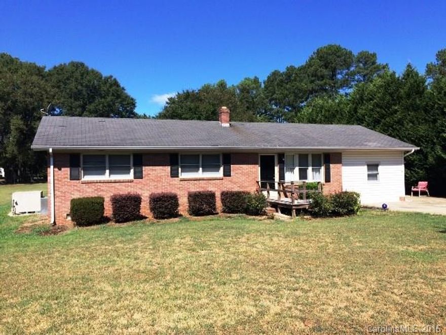 Wonderful country living in mature neighborhood.   Three bedroom, two bathroom brick house.  Carport converted into den.  Deck and patio in back yard.  Wired Workshop. Home to be sold “As-Is”