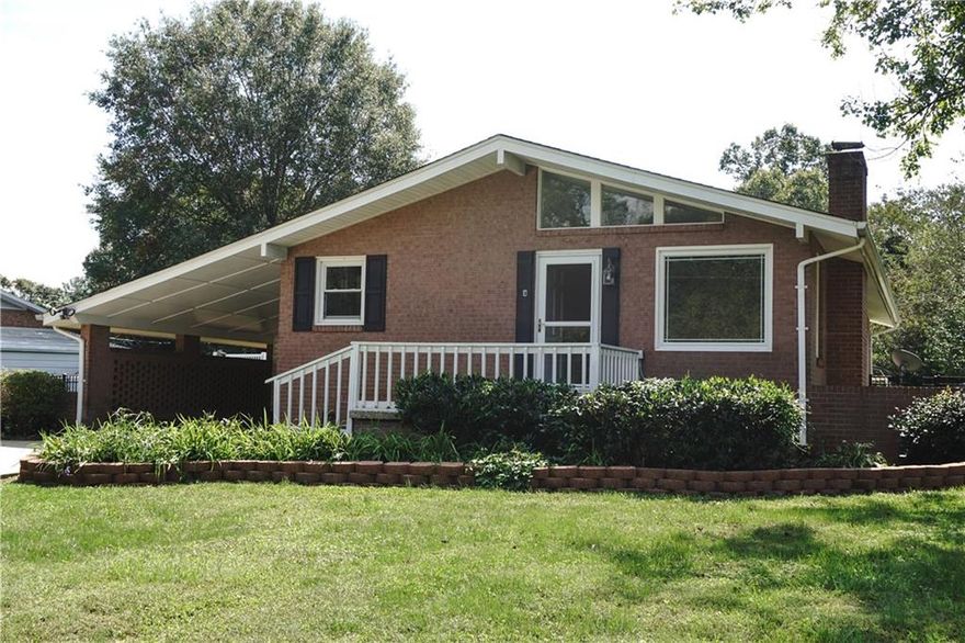Move right into this adorable brick ranch home & enjoy the beautiful ingrnd pool w/a fully fenced bkyrd. FRESH PAINT, nice upgrades +. Inviting LR that offers a gas log FP (w/blwr), vaulted/beamed ceiling & picture window for lots of natural light. The LR opens up into the spacious kit/dining area. Kit/DR offers custom tiled flring, tile cntrtps & bksplsh, freshly painted white cabs, brkfst bar, a gastop range (electric oven) & 2 pantry cabs. The MBR boasts a private 1/2 bath (tile flrs).2 addit. BR's (one w/sliding glass dr access to pool). Hall bath incs tile fls, tub/shwr combo w/tile surround at top & a linen closet. Lndy is located in hall closet w/new vinyl flr (set up for a stackable W/D). Outdr entertaining areas are fantastic-extensive patio areas w/blt-in grill pit & table, ingrd pool,  2 det. bldings (lrg one is ~672 sqft w/part of it htd/cooled by a window unit),dbl det carport. Energy eff. windows & storm drs, att.sgl carport w/storage closet, roof new '18. Don't miss out!