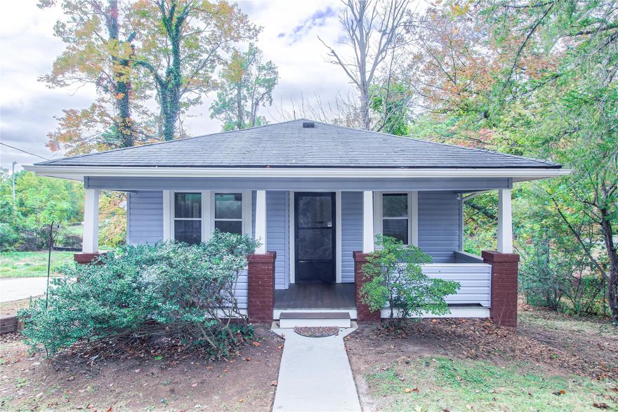Absolutely enchanting bungalow nestled in the heart of Oakley! Situated minutes from local amenities and Asheville downtown, this residence is a perfect blend of convenience and charisma! Soak up the warmth of sunny afternoons on the inviting front porch while surrounded by the serenity of towering trees or enjoy the neighborhood's ambiance, ideal for leisurely strolls . The expansive backyard holds vast potential for investors. Once inside this  1920s gem, be captivated by the  hardwood floors and the ornate fireplace that adds a touch of elegance to the living space. Follow the seamless flow from the dining nook to the  kitchen and onto the utility space. Venturing further, discover two cozy bedrooms and a  bathroom. If you've been on the lookout for a captivating abode with enchanting outdoor spaces, Oakley awaits your arrival!