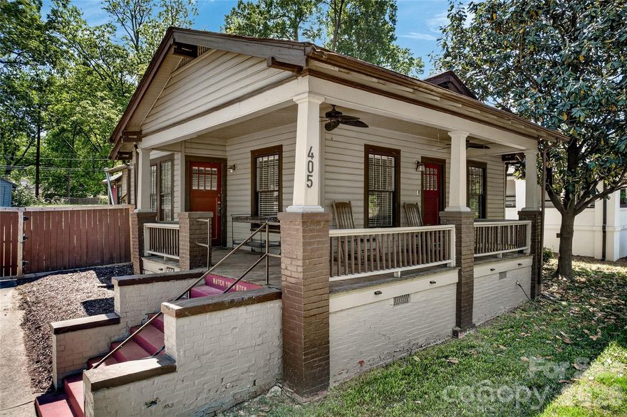 This 3-bed home in the Historic District of Wesley Heights blends historic charm, modern touches, and quick access to Uptown Charlotte. Offering 3 bedrooms, 2 full bathrooms, 1,399 square feet, no HOA, a wrap around front porch, and a rare combined 0.254-acre corner lot that includes the rear lot, this property also features a partial city skyline view from the backyard. Inside, the open layout in the main living area creates an easy flow for both everyday living and entertaining, while hardwood floors run throughout the main living area and secondary bedrooms, adding warmth and timeless appeal. The kitchen features butcher block countertops, stainless steel appliances, and modern finishes that complement the home’s classic appeal. Outside, the wrap around front porch adds welcoming curb appeal, and the corner lot setting offers added presence and outdoor space. Just minutes from Uptown Charlotte, I-77, and I-85, this home offers an ideal blend of character, convenience, and location in one of Charlotte’s most desirable historic neighborhoods.