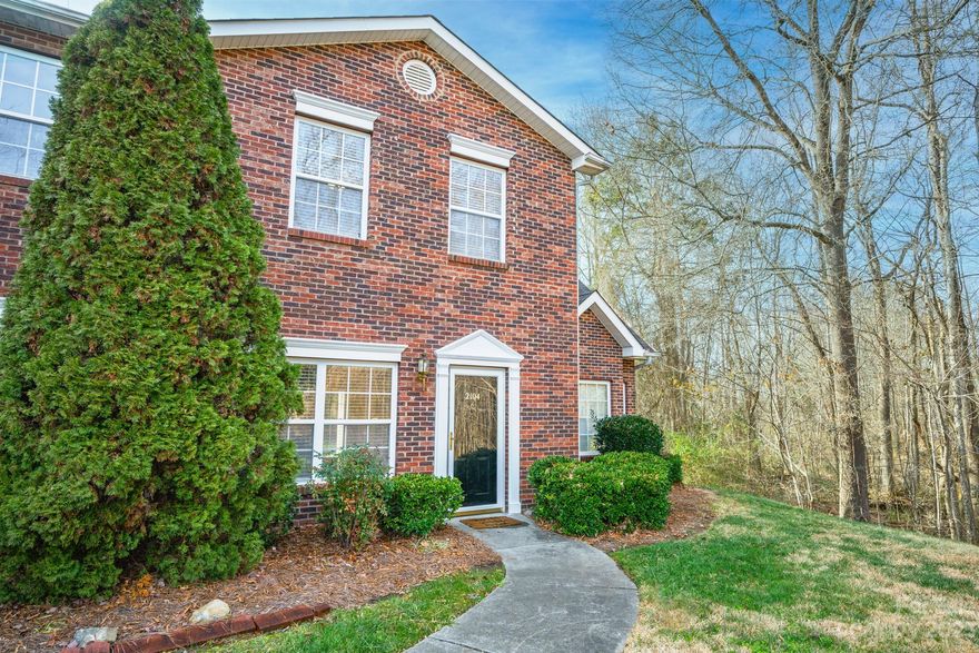 Enjoy living in a gated community convenient to UNC-Charlotte as well as several parks/greenways! This end-unit brick townhome has a primary suite on the main level with a walk-in closet and bath with dual-sink vanity, plus 2 additional bedrooms upstairs with ample closet space and a shared bath. The living room features a gas log fireplace with TV niche above and there is a coat closet near the tiled entry. The well-equipped kitchen includes a smooth-top range, built-in microwave, refrigerator, dishwasher, and stainless sink with disposal. There is a powder room for guests on the main level as well as a spacious laundry room. Washer and dryer convey, as do all kitchen appliances! In addition to pull-down attic stairs, there is a huge, floored, walk-in attic for storage galore or future expansion! Sliding glass doors from the dining room (as well as a back door from the laundry) lead to a covered patio with ceiling fan where you can relax and enjoy wooded views of your back lawn.