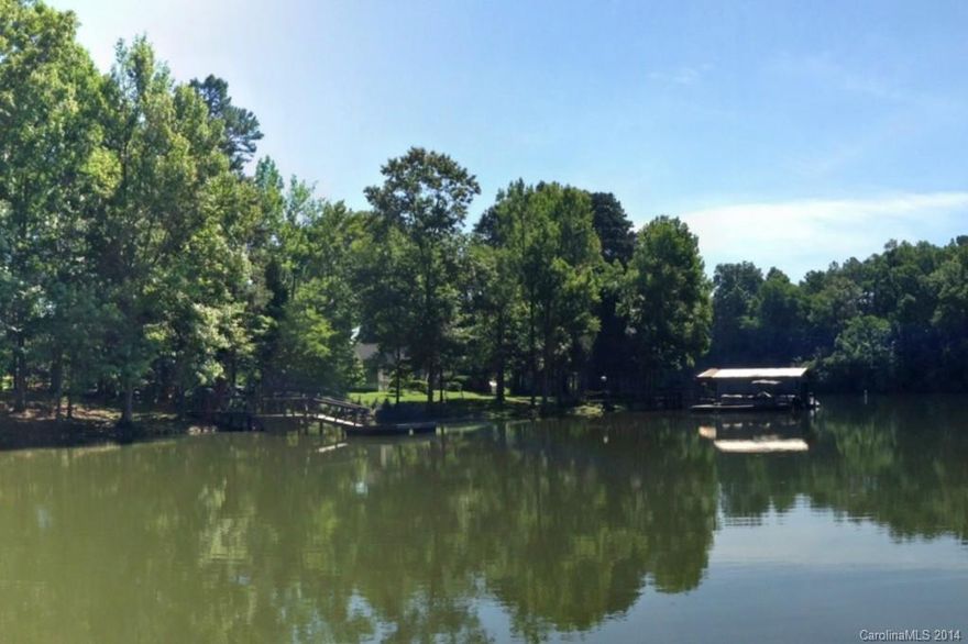 Excellent value on waterfront lot with dock in place!  Intimate lakefront community with fine custom homes, gated access.  Located on a quiet cove, ideal for swimming and paddling around.  Cove opens to a main channel of Lake Wylie where you can enjoy waterskiing.  Lots of natural shoreline on this beautiful section of Lake Wylie.  Priced below tax value!  See tour!