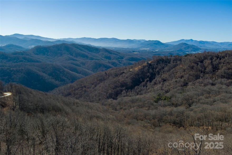 Take in sweeping, year-round long-range mountain views from this beautiful 10.03-acre lot in the gated community of The Summit of Asheville. Sitting at roughly 3,500 feet in elevation on paved Summit View Drive, this property offers something truly special — stunning views to both the east and west, so you can enjoy peaceful sunrises in the morning and unforgettable sunsets in the evening.

The lot already has paved access, underground electric, phone, and fiber internet in place, making it easy to start planning your mountain home. There are several great spots to build depending on the lifestyle you want. Build higher up for big, open views, or tuck in lower on the property for a more private, peaceful mountain retreat.

The Summit of Asheville is a quiet, newly developed community, all at least 10 acres, which keeps things spacious and private. Residents enjoy a community garden, hiking and horseback riding trails, mountain streams, and frequent wildlife sightings. Each lot allows up to three structures, making it a great option for a family compound, or a vacation home. Lots cannot be subdivided, helping preserve the natural beauty and long-term value of the community. A well and septic system will be needed.

You’ll feel worlds away from the noise and traffic, yet you’re still conveniently located — about 20 minutes to downtown Asheville, 25 minutes to Waynesville, close to I-40, and roughly 20 minutes to Asheville Regional Airport.

If you’ve been searching for a mountain property that truly feels special — with space, views, and privacy — this one is worth seeing in person. Contact listing agent for more details!