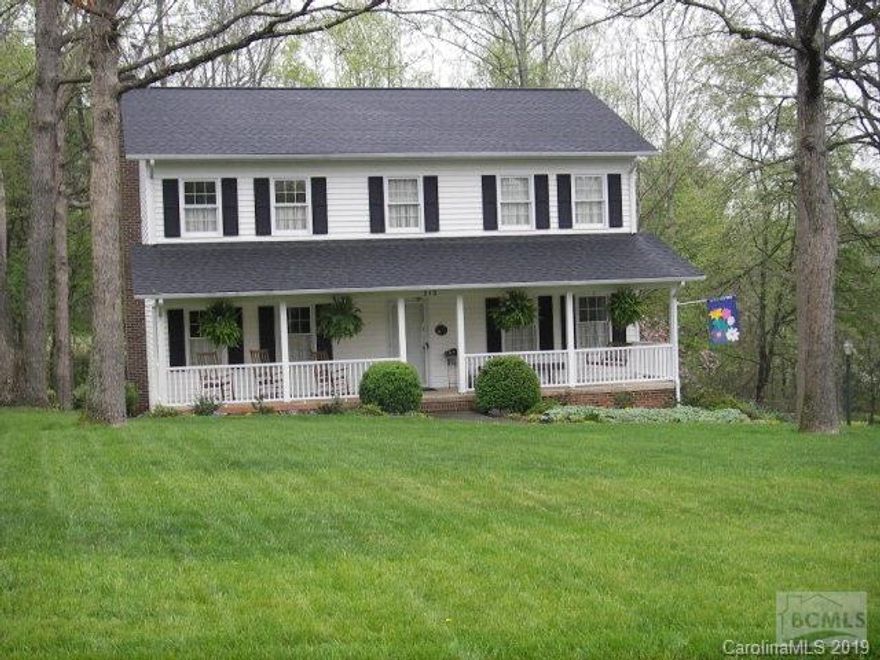 Beautiful two story home in a well-established, desirable neighborhood.  Minutes from downtown Morganton without city taxes.  Home has a welcoming covered front porch with porch swing and room for rockers.  Home is shaded by large trees and is complimented by beautiful landscaping.  Wooded views from the new no maintenance PVC wraparound deck.  Home has a large newly renovated kitchen with granite countertops and heated tile floors!  Home boasts a formal living and dining rooms as well den/family room with brick fireplace.  Large master with walk in closet and attached bath.  Bonus/game room in basement with mini-fridge and sink and easy access to backyard.  Storage or workshop is available in the basement garage.  Home has raised beds for a garden, wooded views, small stream and dog lot in the backyard.  A must see!  SEE MLS 29350 FOR THIS HOUSE PLUS ACREAGE