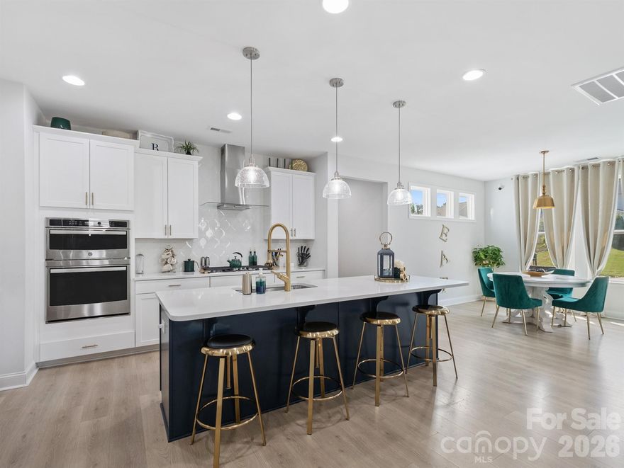 Stunning, model-style home with a heated saltwater In-ground pool and built-in Jacuzzi. Spacious patio featuring an outdoor kitchen and fire pit—perfect for entertaining year-round. Enjoy the screened porch with ceiling fan and a fully irrigated yard for easy maintenance. Permanent track lighting on the exterior of the home that you can control year round via an app.  Inside, you'll find a home office off the foyer with French Doors, a large dining room with built-in cabinets and serving countertop. Open floor plan with a gourmet kitchen including a large island, wall oven, convection microwave, and gas cooktop. A guest bedroom and full bath are on the main floor, while upstairs offers a versatile loft. Custom shelves and wall accent the bonus room. A luxurious primary suite with garden tub, dual vanities, walk-in shower, and large closet. Nestled just minutes from Lake Wylie for all your favorite water activities. This meticulously maintained home is truly move-in ready! Part of the Palisades Community, so you can join for a fee to be a part of the Country Club and Golf Course.