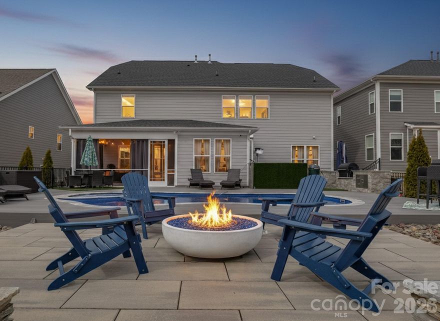 Stunning, model-style home with a heated saltwater In-ground pool and built-in Jacuzzi. Spacious patio featuring an outdoor kitchen and fire pit—perfect for entertaining year-round. Enjoy the screened porch with ceiling fan and a fully irrigated yard for easy maintenance. Permanent track lighting on the exterior of the home that you can control year round via an app.  Inside, you'll find a home office off the foyer with French Doors, a large dining room with built-in cabinets and serving countertop. Open floor plan with a gourmet kitchen including a large island, wall oven, convection microwave, and gas cooktop. A guest bedroom and full bath are on the main floor, while upstairs offers a versatile loft. Custom shelves and wall accent the bonus room. A luxurious primary suite with garden tub, dual vanities, walk-in shower, and large closet. Nestled just minutes from Lake Wylie for all your favorite water activities. This meticulously maintained home is truly move-in ready! Part of the Palisades Community, so you can join for a fee to be a part of the Country Club and Golf Course.