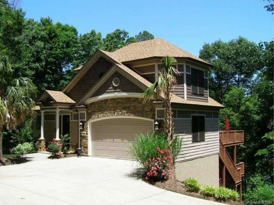 Gorgeous custom home w/ all the bells and whistles! Waterviews. So many fine details throughout - HWs, granite, tile, moldings. Light filled GR/DR/Kitchen area with spectacular windows. Main level Master has deluxe shower with multiple heads. BR, Loft and full bath up. Lower level has Rec Room and wet bar, 2 bedrooms and 2 full baths, + incredible home theater room with stadium seating. Multi-level decks to relax or entertain. City green space between home & lake. Easy to launch your kayak & go!