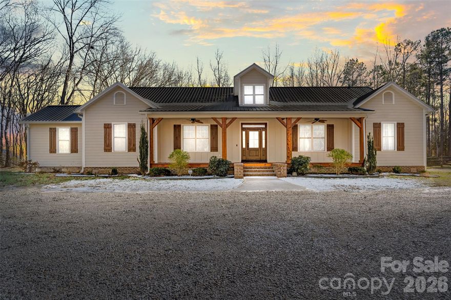 Enjoy privacy w/ 26+ acres in this beautiful custom-built home with so many great features!  The home features a chef's kitchen that opens up to the great room with vaulted ceilings and reclaimed heart of pine flooring.  The primary suite offers dual walk-in closets adjacent to the laundry room.  A heated and cooled sunroom is perfect for observing nature and the fenced back yard.  An outdoor gas fireplace welcomes you to the back deck perfect for enjoying the outdoors.  The covered carport/entertainment area provides a great place to entertain with a kitchen prep room and storage area.  This property includes a 40 x 60 wired shop with 3 large commercial doors and 2 lean to areas for additional storage.  This is a unique property you won't to miss!  An additional 19+ acres adjacent to property can also be available for sale.  All this within 10 minutes to I-77 !