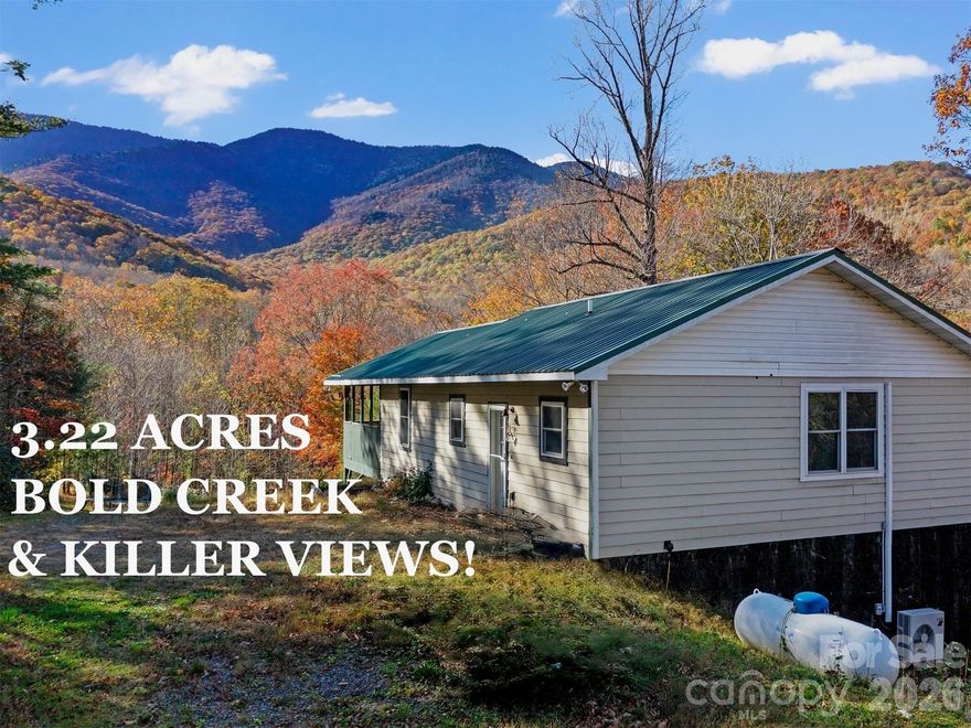 KILLER VIEWS! PRIVACY! BOLD Shuford CREEK - FLOWING THROUGH THE PROPERTY, not just along a boundary! ADJACENT to the NATIONAL FOREST! 3.22 ACRES and NO RESTRICTIONS! This has what everyone is looking for but no one can find. The only problem is that you won't get any work done if you live here. You'll be too busy playing in the creek, wandering trails, or just staring at the ever-changing views of the Black Mountains - the clouds love to get stuck on the peaks, creating some phenomenal sunsets. The house has so much potential with a big open kitchen and large living area on the main floor. Full baths with washer/dryer hookups on both floors leave the spaces flexible. With that layout, I think mother-in-law suite, or perhaps short term rental potential. Nice cool elevation at nearly 3000'. Low maintenance with hardie board siding and metal roof. Large shed for storage. Gentle ground for garden space. The list goes on and on. You need to get out and see it to fully appreciate all that this place has to offer. It is a truly unique find - one that does not come along often.