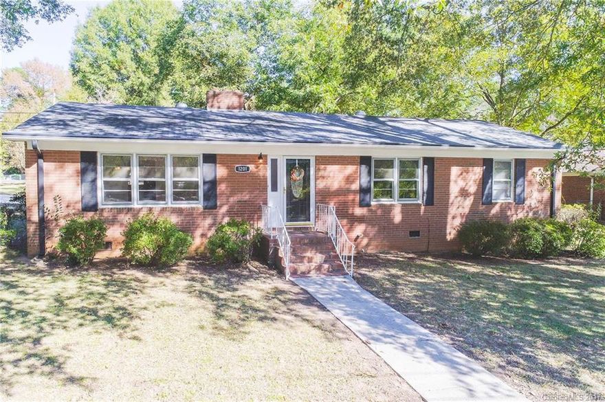 Charming brick ranch home situated on corner lot.  Semi-open floor-plan includes spacious eat-in kitchen,  laundry room with storage and wonderful natural light in living areas.  Home features wood burning fireplace with gas line already installed for conversion option to gas logs.  Exterior features include paver patio, nice size corner lot and side load carport.