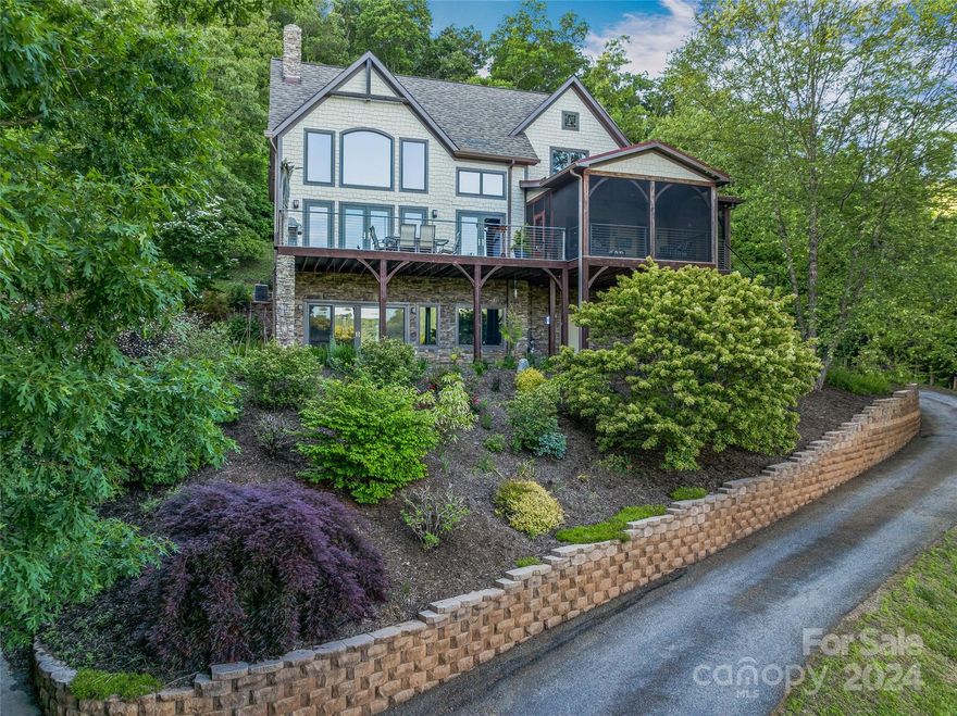 Nestled in sought-after North Asheville, discover a stunning luxury Timberpeg post and beam
home with panoramic mountain views. The dramatic great room boasts a thirty-foot paneled
ceiling and wall of windows, while the elegant SDM Designs kitchen remodel features high-end
appliances and artistic touches. Cozy up by the stacked stone fireplace or unwind on the
inviting screened porch or deck. The main level primary suite offers a walk-in closet with
custom shelving, and a spa-like bath with separate cherry vanities and radiant heat floor.
Three guest bedrooms, including one ensuite, provide comfort and privacy. The terrace level features a family room, kitchenette, home office with built-ins, and a fabulous art studio/craft room, perfect for versatile living. Walk-in closets are in place on two stories for future home elevator, if desired. Enjoy luxurious mountain living and entertaining in this exceptional residence.