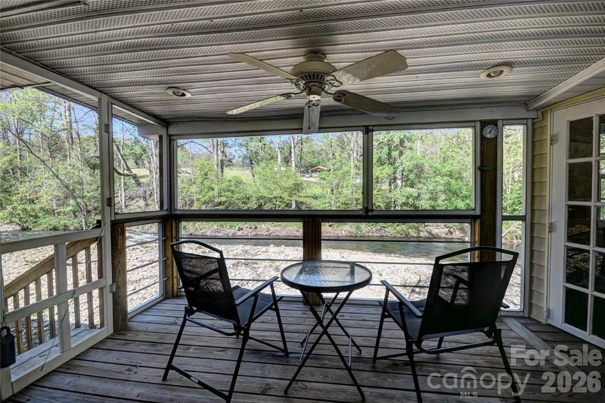 Enjoy the sounds of water music as this home is surrounded on both sides by the rushing Jonathan Creek out back and the lake frontage out front. Enjoy trout fishing, wildlife watching or just relaxataion.  Living area and king size bed are next to the windows to enjoy the creek sounds.  The dining room and kitchen you can enjoy watching the ducks swim in the lake out front.  You can also sit out on the screen porch, enjoy the separate kitchen area while having breakfast coffee, or evening drinks.  Being sold completely furnished and ready for you to start enjoying the cool summer temps.  Per the sellers this home had no flood damge from Hurricane  Helene.
Brand new roof installed October 2025 by David's Roofing Contractors  The porch kitchen has a gas stove, refrigerator and a sink.