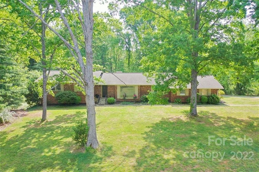 This property offers 5.1 +/- acres with Beautiful, all brick home Nestled amongst mature trees. New flooring, fresh interior and exterior paint, Convenient to I40. This home offers Large Living Room area with gorgeous window that allows for lots of beautiful sunlight to enter the room. Den has built in shelving and cabinetry as well as a fireplace. Kitchen is equipped with all new Stainless Steel Appliances (including refrigerator). Large Basement has built in shelving along one wall and a lovely fireplace as well as a half bath. Back Yard offers privacy and a beautiful setting to enjoy gatherings with friends and family. Main level attached 2 car garage makes it convenient to easily enter the house. Basement offers an additional garage space. Call today to schedule a showing to view this property. You're going to LOVE IT! * This property is in a jurisdiction which will allow the property to be used for either residential or commercial purposes.