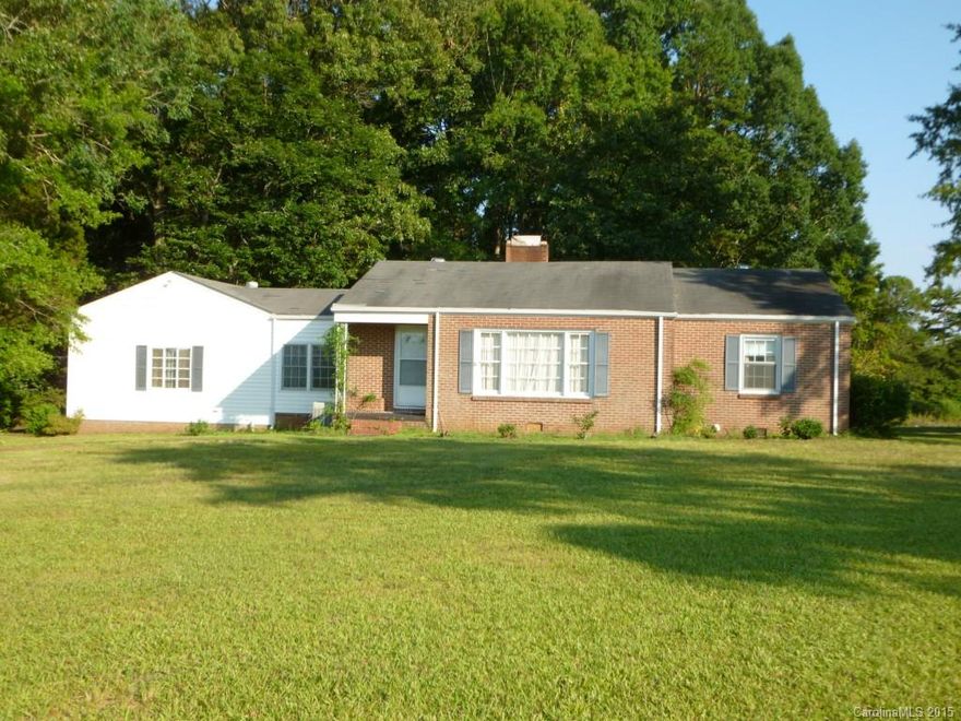 Country living in the Buford school district. This home offers almost 12 acres of land, small pond, room to grow. The house needs updating, but has great potential to turn into a 3 bed using the den with fireplace as a master. The layout gives plenty of room to expand. Hardwood floors under the carpet, sunroom that is cooled. The land makes a great place to build your dream home in the future. Come see all the possibilities this home has to offer.