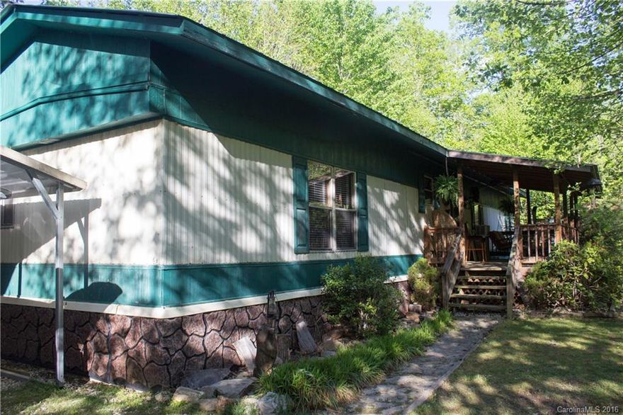 Enjoy life in this private & secure mountain getaway! Watch wild deer from the front deck with view of waterfall. Recent complete roof-over & double windows add to eco-friendly home. Large rear deck overlooks treetops & mountains. Elevated kitchen, fireplace, laundry room with washer/dryer. Fridge, stove, furniture & 2 sheds included. Broadband Internet & TV services available. Owner financing available for qualified applicant with 20% down.