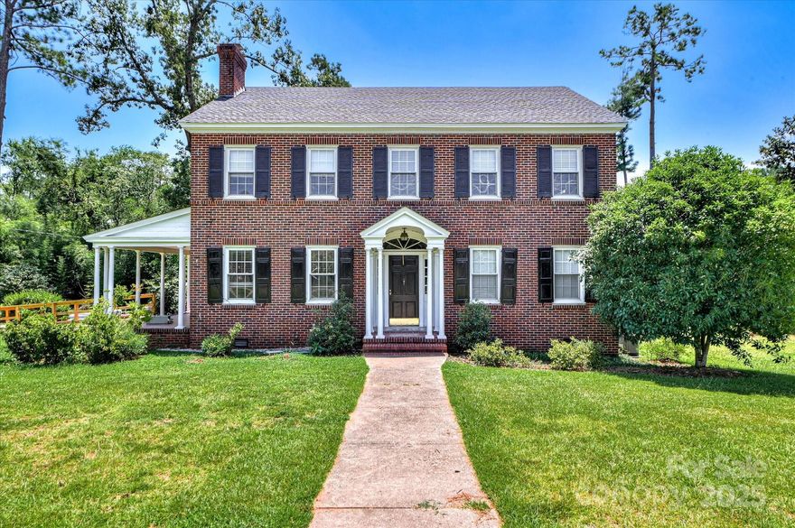 Here is your second chance to make this house your home! Tradition shines in this two story 100% brick home on 2.3 acres. Lovely foyer opens into formal dining room with loads of sunshine. Across the foyer is the expansive living room with fireplace and detailed mantel. Living room has outside entrance from covered side porch where you can rock and sip lemonade. Downstairs bedroom and updated bath. Kitchen with all appliances overlooks a new screened back porch and quick entry from the open carport. Cozy breakfast room begs for tea or coffee in the morning. Upstairs boasts 4 bedrooms and update bath. Hardwood floors throughout home. NEW roof! Lots of outside space to enjoy and room to garden. Landscaping of old camellias offer lots of southern charm. Utility building outside and an older barn is located on back lot. Walking distance to Historic downtown Edgefield. NO city taxes.