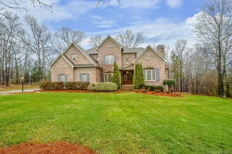 Builder's Personal Residence! STUNNING custom on lush level acre with wooded Privacy. Elegance at every turn: hardwoods, millwork, premium granite, marble & tile, tray & coffered ceilings. Veranda with Nature’s view! Chef’s Kitchen with commercial appliances (Wolf, Viking), custom cabinetry, pot filler, & more! Luxurious Main Level Master Suite with designer Bath. THE Media Room. Set in estate neighborhood with fishing pond. 5 minutes to shopping & Sun City,15 to Ballantyne,5 to Downtown Waxhaw!