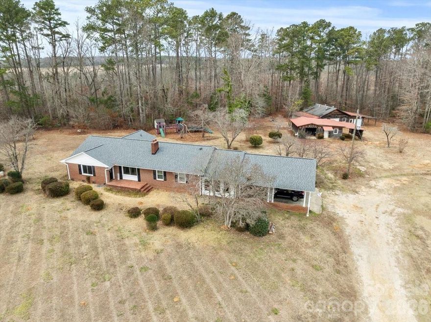 If you’ve been dreaming of a little land and a lot of functionality, this one delivers! Set on 6.14 acres in Chesterfield County, this 2,536 sq ft brick home offers 3 bedrooms and 2 baths, a welcoming sunroom, and an oversized laundry/storage area that keeps life organized. Recent upgrades shine: roof (2020), appliances (2022), replacement windows (2023), fresh paint, refinished hardwoods (2026), and new sunroom flooring (2026). With dual HVAC systems and county water, the home blends comfort with convenience. The real show-stoppers are outside—attached 2-car carport, chicken coop, and two massive wood barns/workshop/garage spaces with concrete floors and two roll-up doors—ideal for a shop, storage, or serious projects. Room to live, work, and play—don’t miss this unique acreage property.