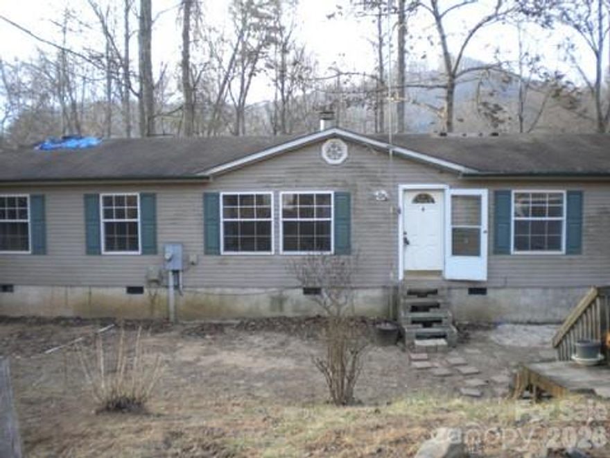 A Fairview doublewide just waiting for your TLC. Home sits on 2  acres at the top of the ridge in a private setting but is 5 minutes to all shopping and services on 74A. Convenient to Asheville and the Blue Ridge Parkway. A diamond in the rough that can be the perfect house in the woods.