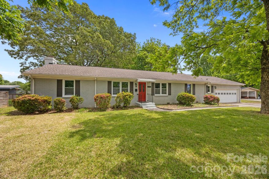 Welcome to one of the largest ranch homes in desirable Windsor Park area, perfectly positioned on an expansive .63-acre lot. This property offers an incredible combination of space, updates, and location, with a generous front and backyard, mature pecan trees, and direct access to Kilborne Park just across the street. Inside, the home has been thoughtfully updated throughout and is truly move-in ready. The kitchen and baths feature granite countertops, complemented by stainless steel appliances, tile flooring, and updated fixtures and hardware. Hardwood floors add warmth and character, while fresh interior and exterior paint give the home a clean, modern feel. Enjoy outdoor living on the oversized 20x25 deck, ideal for entertaining or relaxing while overlooking the private backyard. Major system upgrades provide peace of mind, including a full roof replacement with architectural shingles, new HVAC system with all new ductwork installed in the attic, updated plumbing with PEX water supply lines and PVC drainpipes, blown-in attic insulation, and all new double-pane energy-efficient windows. The home was originally built with fully grounded electrical, and the water heater was recently replaced in 2023. Additional highlights include a RARE attached, over size  two-car garage, updated landscaping, and a functional layout that offers both comfort and flexibility. Located just minutes from Plaza Midwood and NoDa, this area offers the perfect blend of established neighborhood charm and urban convenience. You will enjoy easy access to local dining, breweries, shopping, and entertainment, along with a quick commute to Uptown Charlotte. The area is known for its tree-lined streets, larger lots, and strong sense of community, making it one of Charlotte’s most appealing in-town neighborhoods. With its size, upgrades, and unbeatable setting this is a standout opportunity you won’t want to miss.