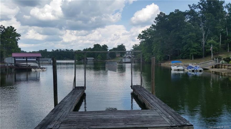 Incredible opportunity to own WATERFRONT home on Lake Wylie! Over 3,000 square feet, featuring two decks, a boat dock, car port, and over an acre of land! No HOA! Deep water cove with excellent views! Seize this rare opportunity to own waterfront at an incredible price! Don't miss out. Won't last long!