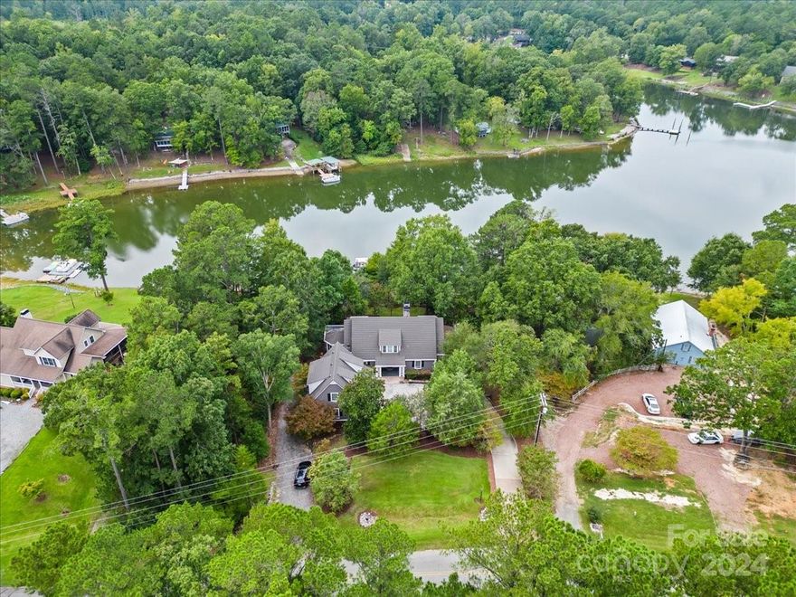 Beautiful custom-built home on Lake Wateree convenient to both Columbia and Charlotte with 230 ft of lakefront, stunning views, and an acre of land. Features include: high ceilings, heart pine floors, and gorgeous reclaimed Pecky cypress paneling; three kitchens and a butlers pantry; a master suite with private sitting room, large soaking tub, and separate shower; to the large family room with custom built-ins and a slate fireplace. These luxurious details span more than 6000 square feet over 3 full floors. Accommodations include 5 bedrooms and 5 ½ baths in the main living space and a 1 bed 1 bath mother-in law suite with kitchenette. The home features many spaces to gather from the sunroom with 180 degree lake views; multiple rec rooms, partially screened in deck with jacuzzi, a covered patio with stunning brick archways, and a dock gazebo with wrap around seating. Enjoying the lake comes easily with a slide, deep water off the dock, and a boat ramp. Schedule your showing today.