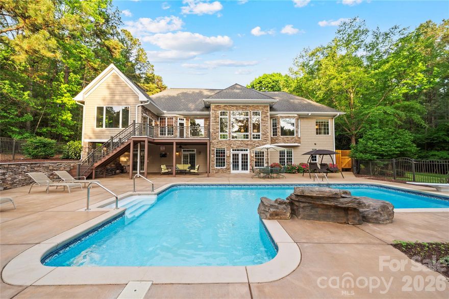 Rare and remarkable gem! Spanning 4.49 acres on the shores of Lake Tillery, this exceptional estate showcases a rare mix of wide-open land, generous waterfront, and quiet seclusion. Welcome to a property where timeless elegance meets the ease of lakeside living. With over 4,700 square feet of thoughtfully curated space, this residence offers a refined yet inviting atmosphere designed for both elevated entertaining and quiet, meaningful moments.

The main level unfolds with warmth and understated sophistication, as natural light pours into expansive living spaces and fireplaces create an inviting ambiance from the moment you enter. At the heart of the home, a beautifully appointed kitchen features a generous island, custom cabinetry, breakfast bar, and premium appliances—perfectly suited for everything from intimate dinners to effortless entertaining. Just beyond, the main-level primary suite serves as a serene retreat with a spa-inspired bath and peaceful views that invite you to unwind. A sunroom, private office, and additional gathering spaces complete the main level, seamlessly blending comfort and function with timeless style.

Below, the basement is designed with both relaxation and versatility in mind. Offering 3 bedrooms and 3 full baths, this level is ideal for hosting guests or accommodating with ease. A spacious den with fireplace, wet bar, recreation areas, and a dedicated exercise room create a private haven for leisure, wellness, and entertainment.
Outdoors, the property transforms into a true lakeside sanctuary. A stunning saltwater in-ground pool anchors the backyard, creating a tranquil setting for sun-drenched afternoons and relaxed evenings under the Carolina sky. Expansive decking and covered porches provide seamless indoor-outdoor living, inviting you to gather, dine, and take in the gentle water views at every turn. Your private boathouse with lifts offers effortless access to the lake, where days can be spent boating, fishing, or simply enjoying the calm of the water. Surrounded by mature trees, open pasture, and additional outbuildings, the property offers both privacy and endless possibilities.

This is more than a home—it is a place where luxury feels effortless, where every detail invites you to slow down, and where life on the lake becomes part of your everyday rhythm.