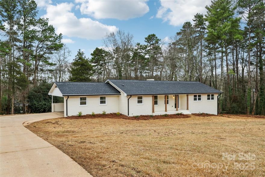 If you are looking for a brand new home but still want the charm of a traditional house in an established neighborhood, this property is perfect for you. This 1968 ranch features freshly painted brick for a clean, modern look and sits on a large 0.84-acre lot. This gives you the kind of outdoor space that is hard to find with new constructions today. While the exterior has that classic feel, the interior has been completely transformed. Every major system and surface is new, including the roof, HVAC, plumbing, and electrical. Inside, you will find fresh sheetrock, new flooring, and updated lighting throughout.

The home features three bedrooms and two modern bathrooms with an open floor plan that makes the living space feel bright and connected. The kitchen is updated with new cabinets, and the house even includes two working fireplaces to keep things cozy—one on the main floor and one in the basement.

The full basement is a standout feature of this property. It provides an incredible amount of extra room that is great for storage or for creating a bonus space for entertainment, a hobby room, or a dedicated workshop. For parking, there is a double carport. You can enjoy the fresh air from the covered front porch or the back patio, both of which overlook your spacious yard.

Located in the quiet hamlet of New London, this home is in a prime spot for anyone who loves the outdoors. Badin Lake and Morrow Mountain State Park are just minutes away for weekend adventures. You also stay connected to the city, as it is only a 45-minute drive to I-485 and an hour away from Charlotte International Airport.

Living here also means joining the Stanly County community, which is known for its beautiful rolling hills and the ancient Uwharrie Mountains. The county offers a great mix of rural peace and local convenience, featuring many family-owned farms and several local vineyards. It is a place where you can enjoy a slower pace of life while still being close to everything the Piedmont region has to offer.