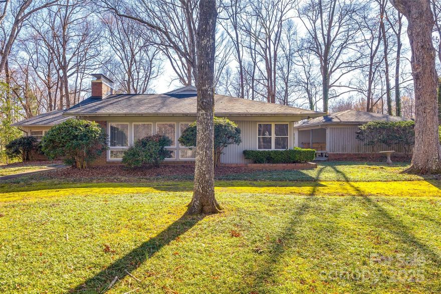 Welcome to this Town & Country Estates home with a beautiful one acre lot!  Home is very close to Carmel Road Park and is surrounded by trees, this is a rare opportunity to own a property with a beautiful private lot while having the convenience of an in-town location! Home is minutes from South Park. This 4 bedroom, 2 1/2 bath home has a unique floor plan and is full of charm.  Home is in need of updates, but it does feature a new roof and HVAC installed 2024.  Home features two fireplaces, one in kitchen and the other in the family room with beautiful stone surround.  Buyer could either restore this home or build a new home on the lot.  The possibilities are endless! Note that home is being sold as is and no repairs will be made.