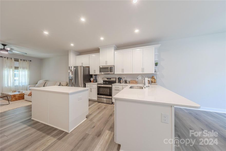 Better than new 3 story new construction townhome! Amazing location walking distance to all that Noda has to offer. Lower level is the perfect flex space that could be used as an office, bonus space or even bedroom with the walk-in closet. The second floor features luxury vinyl flooring, spacious balcony and upgraded light fixtures. The open concept kitchen showcases white 42 inch staggered cabinets with brushed nickel hardware, tile backspash, quartz countertops, stainless steel appliances and pull out trash cabinet to maximize space. The laundry is conveniently located on the 3rd floor with primary suite and ensuite bathroom and second bedroom with ensuite both featuring ceiling fans.