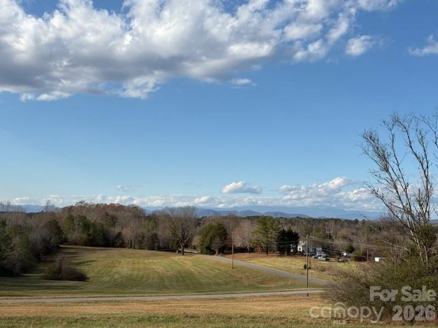SECLUDED VERY LOW TRAFFIC 53.18 ACRES Located at #211 + #212 North Carolina PAVED NO OUTLET FARRIS ROAD (State Road #2287) this former FARM LAND offers MANY possibilites! 
*23 +/- ACRES in Open Grassed pastureland with MANY LONG RANGE VIEW HOMESITES in the PASTURES, 30+/- ACRES in mature WOODS, with #TWO Streams crossing the rear acreage in woods at the #18.1 ACRES located in SOUTH CAROLINA with several homesites on top of RIDGELINE in the woods, *This property ADJOINS the State of South Carolina Parks and Recreation 100+ Acres AND The State Of North Carolina 582+ Acres located at the end of Farris Road. INCLUDES: Old Farm House (916 Square Feet) Built Year 1934 in severe need of repair, or Demo, Two former now empty Chicken Houses (18,000 and 19,800 Square Feet), Plus several OLD SHEDS and an OLD BARN.  Property has 1300+/- Feet Paved Road Frontage on old farmhouse side of Farris Rd. with 850 +/- Feet Road Frontage across road from farmhouse.
***LOW Property Taxes (Please See attached invoices)
*Water is supplied by a well, Septic Tank on property, REA Electicity.
*This property is located within 3.3 Miles of Exit #5, Interstate I-85 in Kings Mountain, Cleveland County, North Carolina, however, it "IS in the COUNTRY" totally secluded from any heavy traffic.