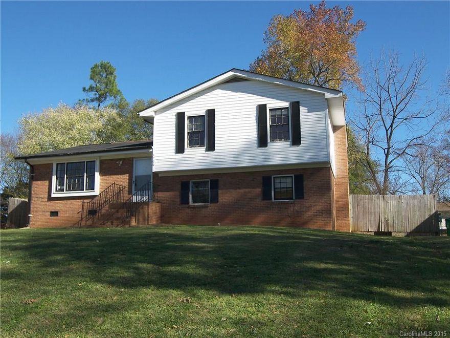 Tremendous potential! Brick and vinyl split level home on a .28 acre lot in Forest Pawtuckett. Lots of square footage. Four bedrooms with two full and one half bath. Fireplace with brick surround and elegant mantle. Tile floor in bathrooms. Tile floor in kitchen. Some laminate flooring. Central air, gas heat, city water, city sewer. Outbuilding, back deck, fenced yard.